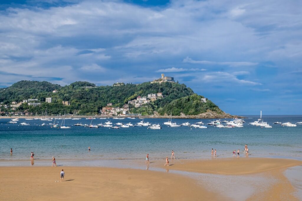 a beach with people and boats