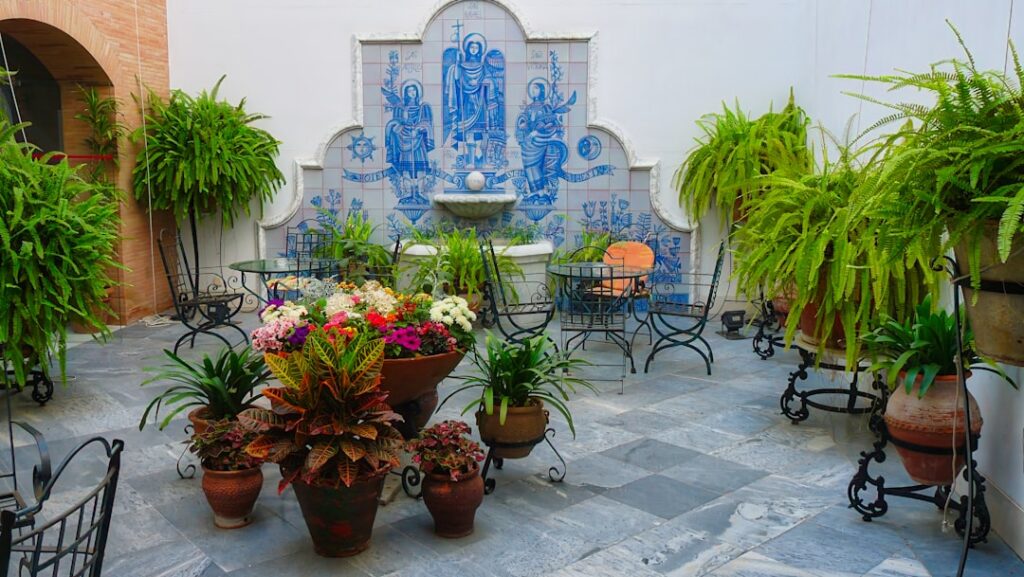Courtyard with tiled fountain and potted plants