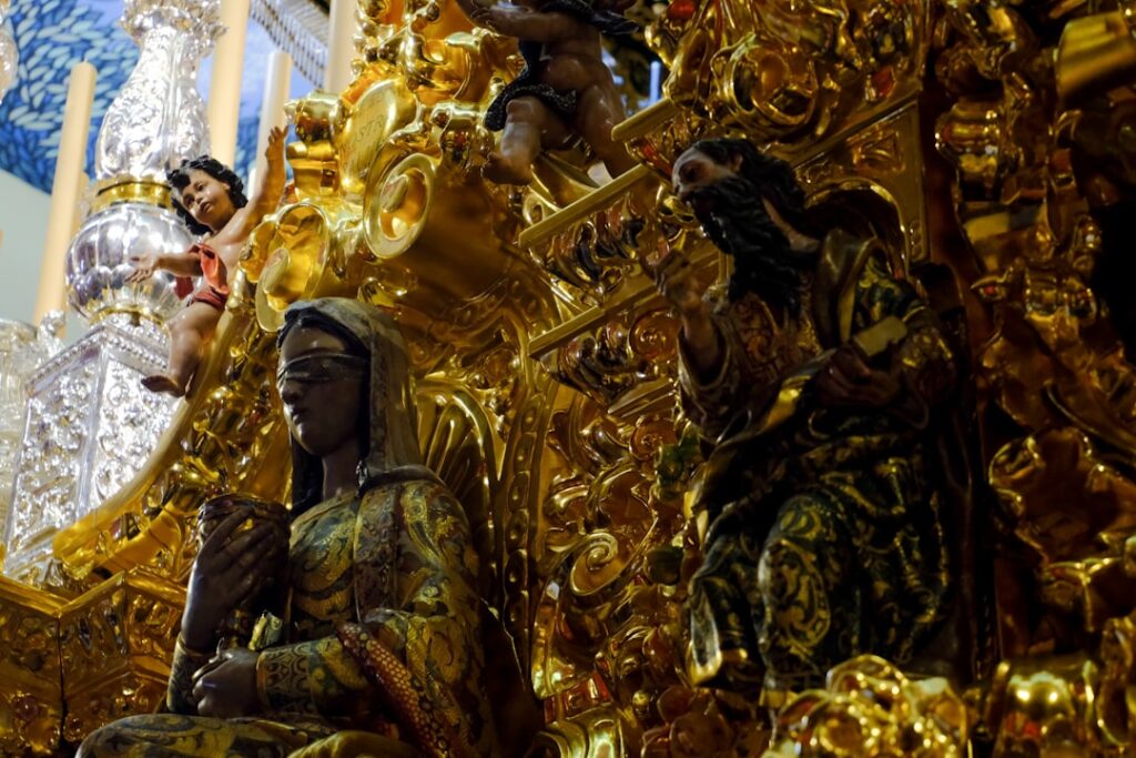 Ornate gold sculptures adorn an interior.
