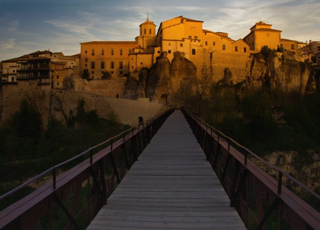 Bridge leading to a sunlit medieval city